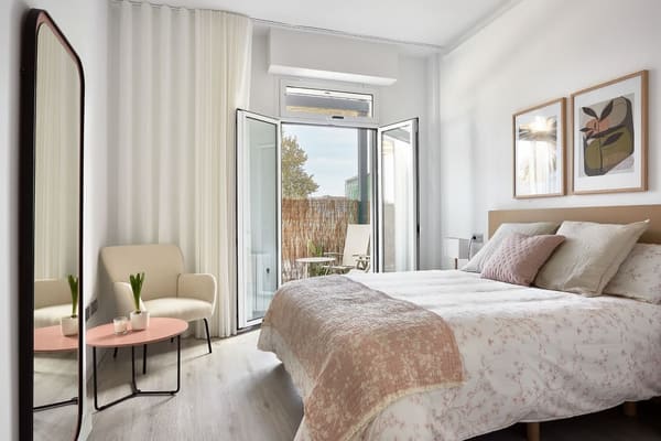 Bright modern bedroom with balcony access